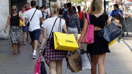 Shoppers carrying bags on Oxford Street