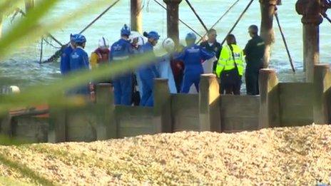 Emergency services on Eastbourne bach after man fell from pier