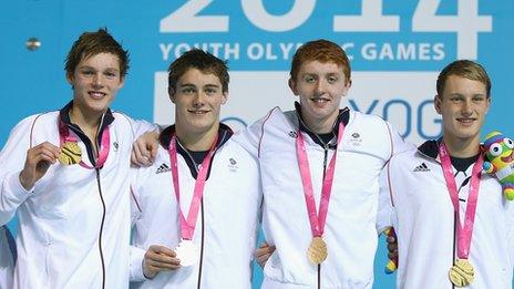 Team GB's 4x100m freestyle medley team pose with their gold medals.
