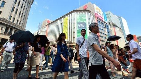 June 14, 2014 people strolling in Tokyo's Ginza shopping district.