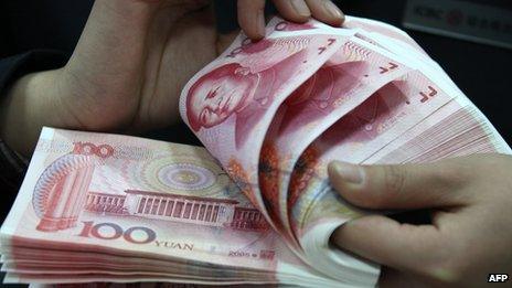 A woman counting Chinese yuan