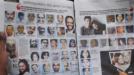 A man reads a newspaper with portraits of Westgate mall victims on 19 September 2014