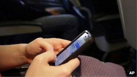 Woman uses phone on plane