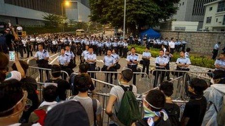 Police line up next to government offices in Hong Kong on 3 October 2014