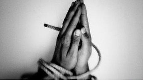 Hands bound by rope (slavery)