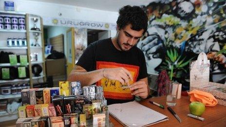 Juan Manuel, owner of the first shop dedicated to cannabis merchandising in Montevideo, rolls a joint on April 24, 2014.