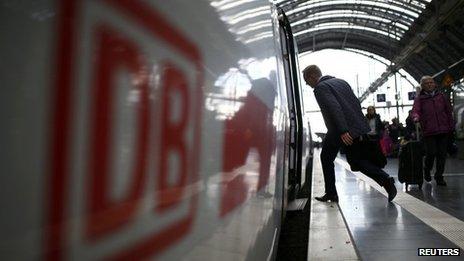 Passenger stepping onto Deutsche Bahn train