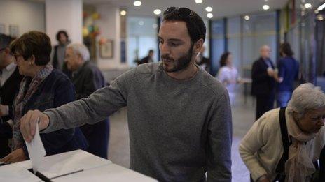 a man casts his vote in the informal poll (9 November 2014)