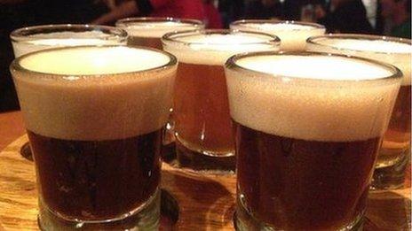 Seven glasses of beer on a platter
