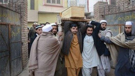 Pakistani mourners carry a coffin during the funeral ceremony for victims of an attack by Taliban militants at an army-run school, in Peshawar on 17 December 2014.