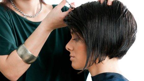 A woman having her hair cut