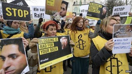 People take part in an Amnesty International protest in front of the Saudi Embassy in Vienna, Austria, 16 January 2015