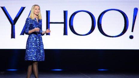 Marissa Mayer in front of Yahoo logo
