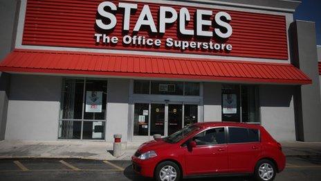 Staples store with car in front