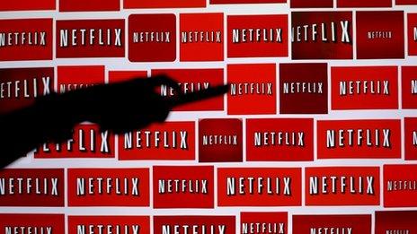 Netflix logos with hand
