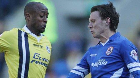 Joe Mason of Cardiff City is tackled by Nadjim Abdou of Millwall