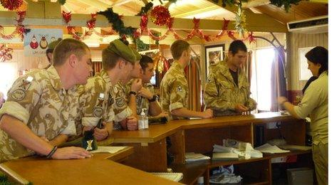 Soldiers queue for a welcome drink at Camp Bastion