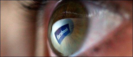 Facebook logo reflected in eye, Getty