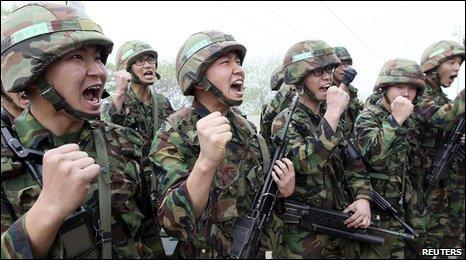 South Korean soldiers shout slogans before they conduct a military drill near the demilitarized zone (DMZ) separating South Korea from North Korea in Yanggu, about 180 km (112 miles) northeast of Seoul, May 24, 2010