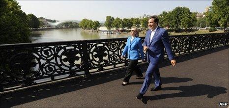 US Secretary of State Hillary Clinton (left) crosses a bridge in Tbilisi with Georgian President Mikhail Saakashvili, 5 July