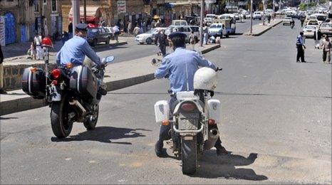 Yemeni policemen attend the scene where an attack took place on a convoy carrying a senior British diplomat in Sanaa.
