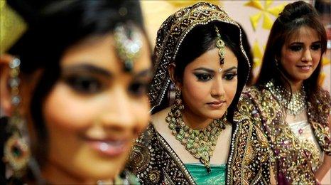Indian models display bridal wear during a bridal make-up workshop in Amritsar, August 2010