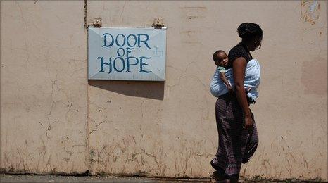 A mother walks past the Door of Hope orphanage in Berea, central Johannesburg