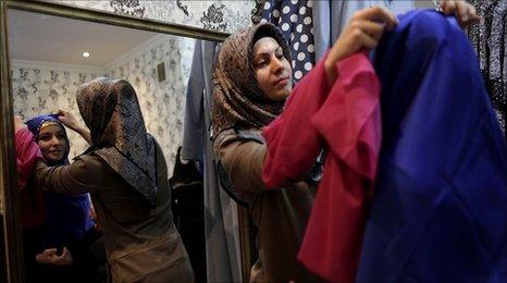 A woman tries on Islamic clothing at a shop in Grozny, Chechnya, 9 March 2011