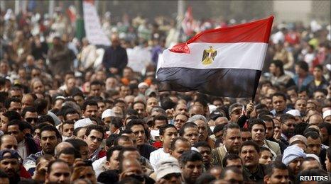Protesters wave an Egyptian flag in Cairo