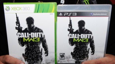 A shopper holds two copies of CoD: MW3