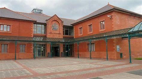 Llandudno Magistrates court exterior - showing redbrick building with a green glass canopy on the exterior