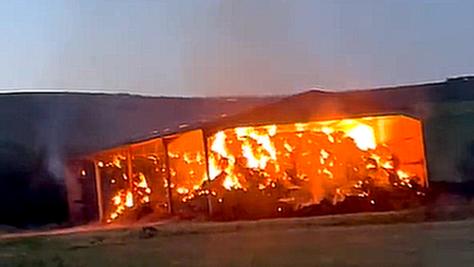 A large barn on fire.