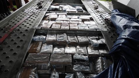 Blocks of drugs in trailer bed at farm