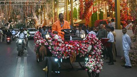 A decorated vehicle rides past Chairman of Reliance Industries Mukesh Ambani's residence Antilia in Mumbai on July 3, 2024