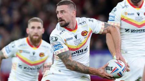 Micky McIlorum of Catalans Dragons passes the ball during the Betfred Super League Final match between Wigan Warriors v Catalans Dragons at Old Trafford on October 14, 2023 in Manchester, England.