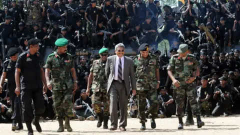 Getty Images Sri Lanka's former Defence Secretary Gotabhaya Rajapaksa (C) pictured in 2010