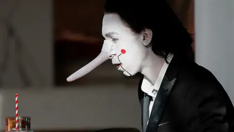 A person wears a costume at a cafeteria during the pop culture exhibition MCM Comic Con at London's ExCel centre, on 24 October 2021