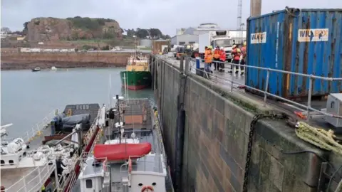 Jersey Maritime Administration A view of the harbour showing the quayside, the ladder and the two ships. 