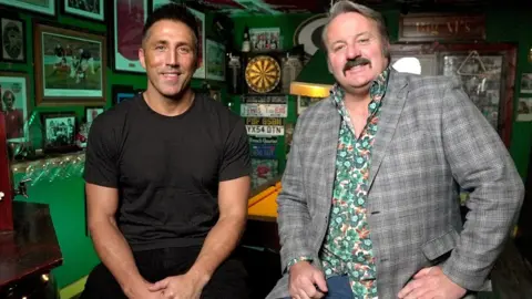BBC Gavin Henson and Mike Bubbins smiling at the camera in Mike's bar