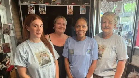 Dom Cotter Four people standing in a line smiling, with t-shirts on which it says 'Danny's Day'