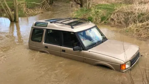 Nottinghamshire Fire and Rescue Service car stuck in floodwater