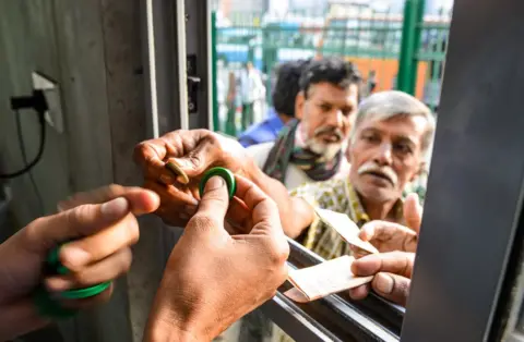 Asif Saud Customers buying tokens for breakfast at the canteen