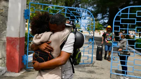 A prisoner embraces his sister as he leaves La Lima prison in Havana
