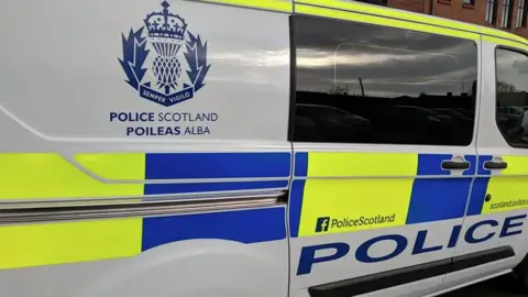 the side of a marked Police Scotland van