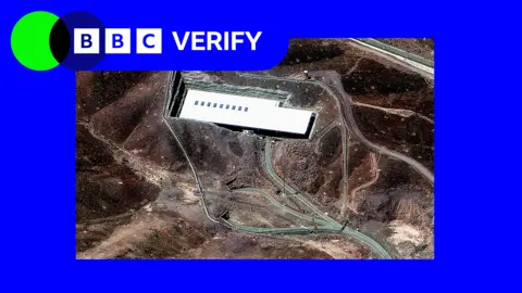 In the background: A satellite image of Iran's Fordo nuclear site. A BBC Verify logo is in the top left-hand corner. 