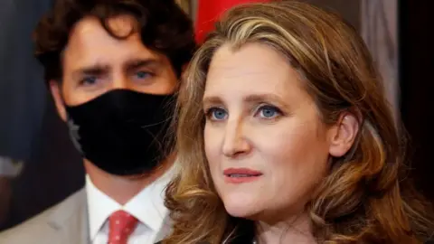 Reuters Finance Minister Chrystia Freeland speaks to reporters next to Prime Minister Justin Trudeau in Ottawa,