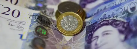 Getty Images One pound coin and £20 notes