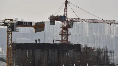 Getty Images Indian construction workers work on a high-rise building. India's prime minister, Narendra Modi, presents the Union Budget 2025-26 in parliament in Hyderabad, India, on January 30, 2025.