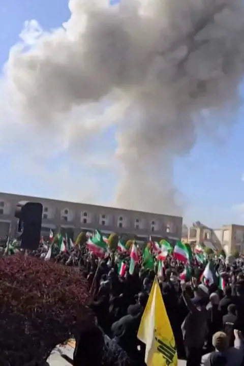 Reuters Screengrab of video showing smoke rising into the sky near a rally by government supporters in central Isfahan, Iran (9 March 2026)