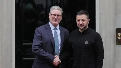 Standing outside of No10 Downing Street, Prime Minister Sir Keir Starmer (on the left) shakes hands with Ukrainian President Volodomyr Zelensky